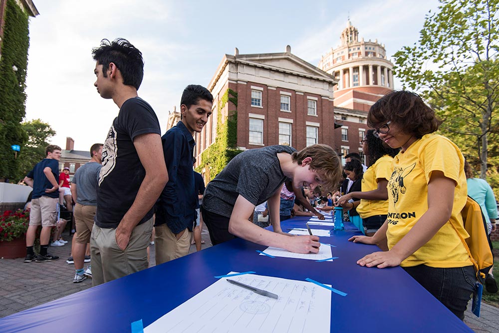 long line of students signing the class roll