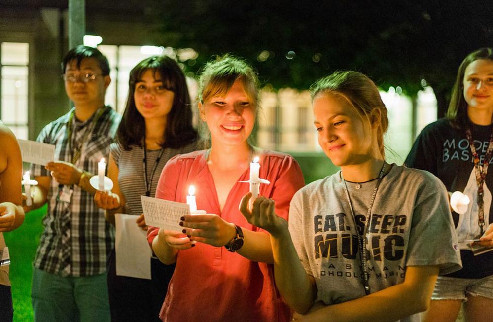 students holding candles