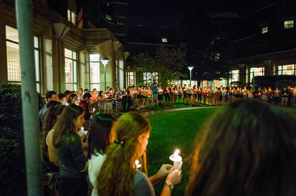 students holding candles