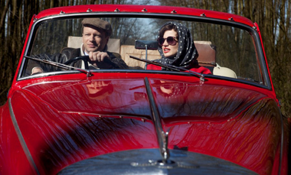 Feature image couple driving in classic car