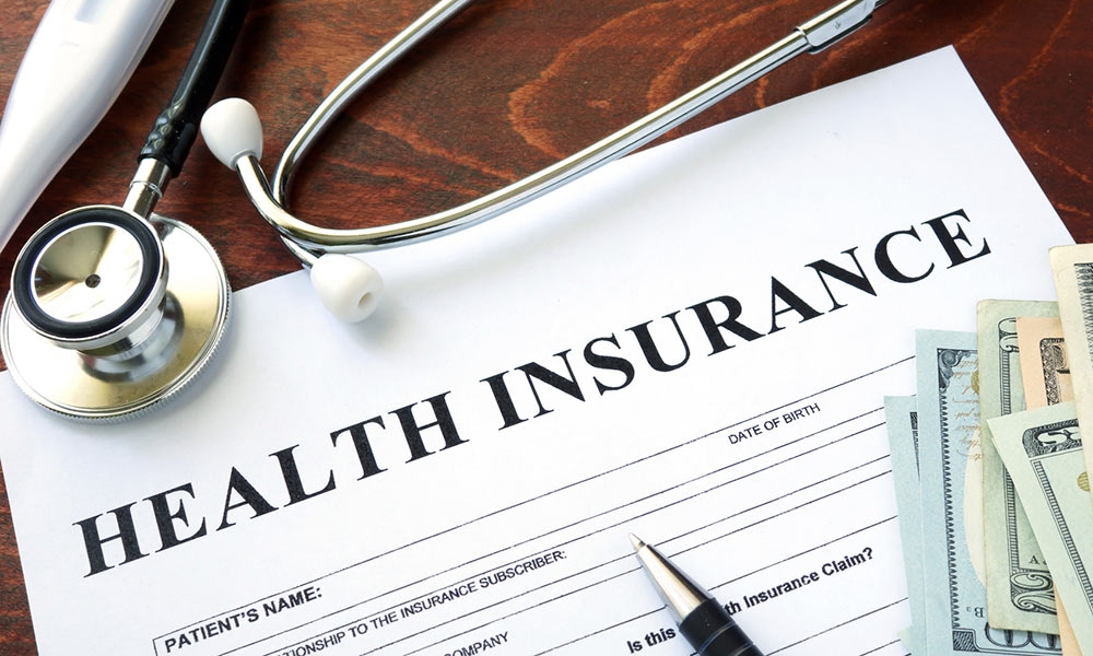 An insurance form, a stethoscope, a pen and cash
