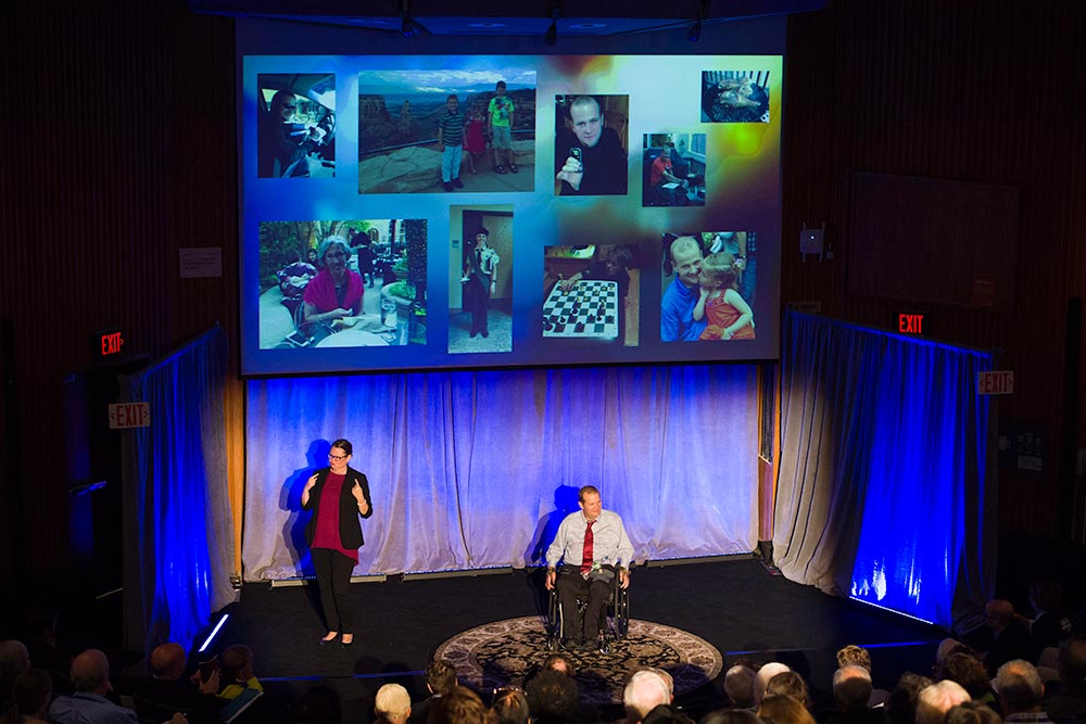 speaker in a wheelchair and sigh language interpreter on stage