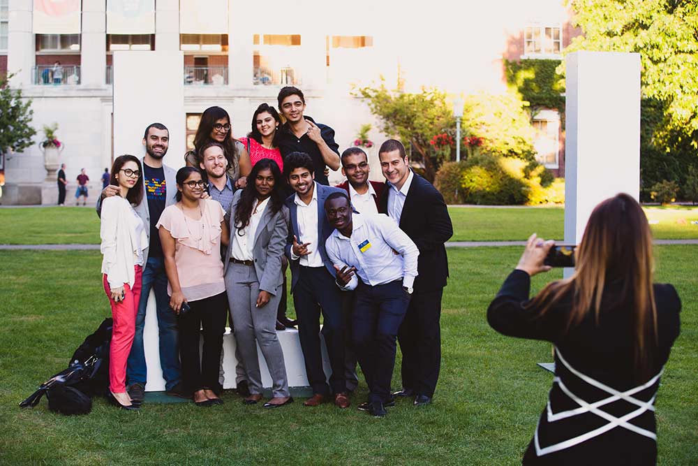 students posing with giant letters on the quad