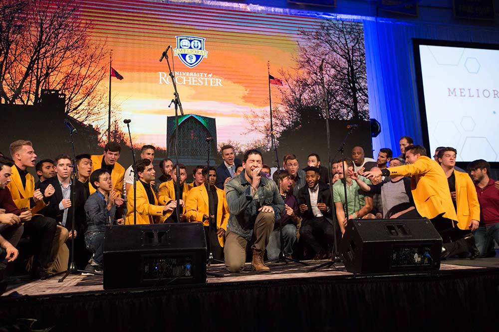 large group of singers perform on stage