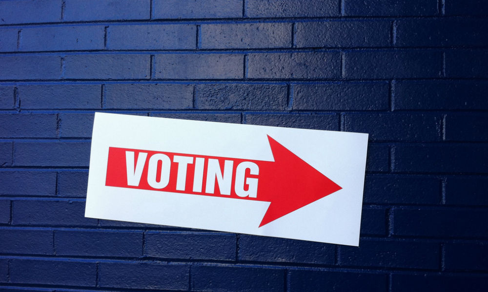 Feature image sign with an arrow says VOTING