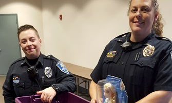 Feature image Two women safety officers next to toys and a purple bin