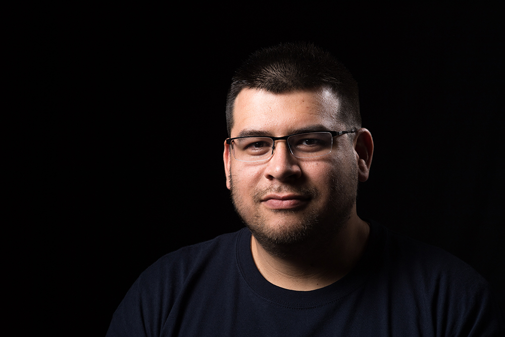 man in front of black background