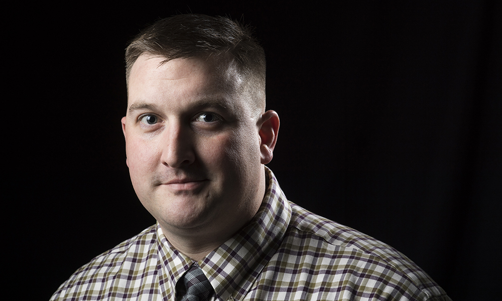 man in front of black background