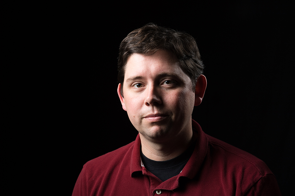 man in front of black background