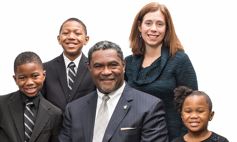 two adults and three children dressed in formal wear