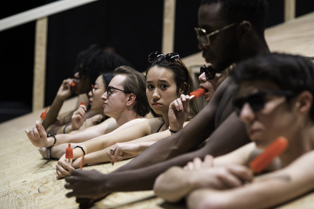 group of student actors in a row, on a very steep stage