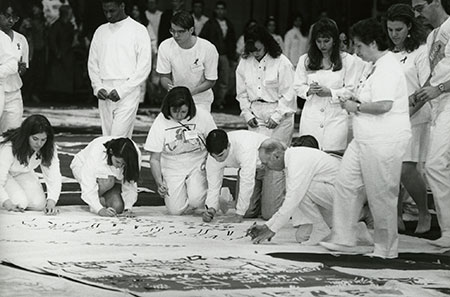 archival photo of people signing panel