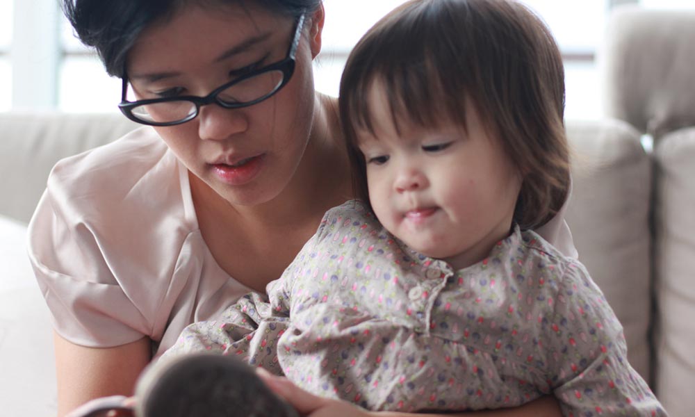 Feature image A mother reads to her child.