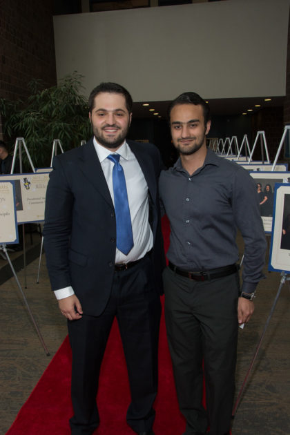 two student pose at award ceremony