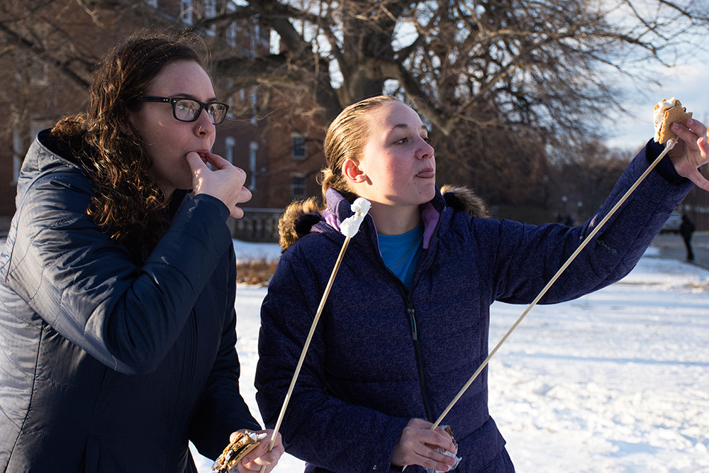 two students eating smores.
