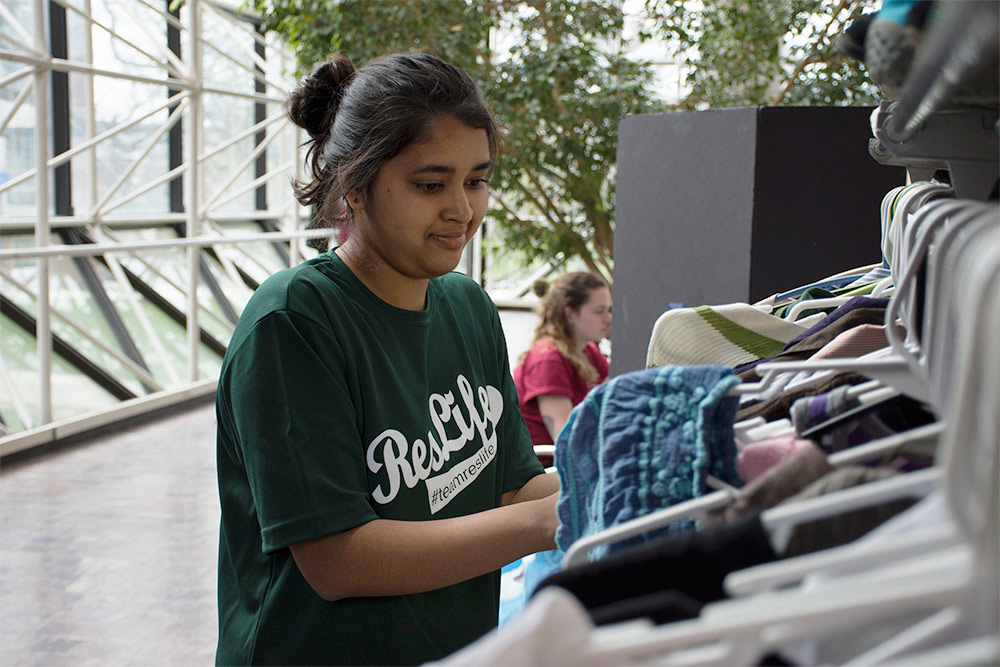 young woman looking at clothing