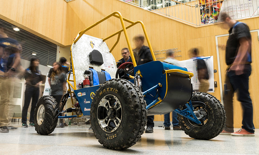 Feature image metal framed open air baja car surrounded by students