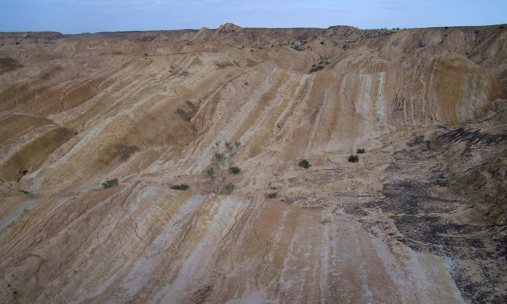 expansive photo of Tibetan plateau, showing the layers of sediment in the land