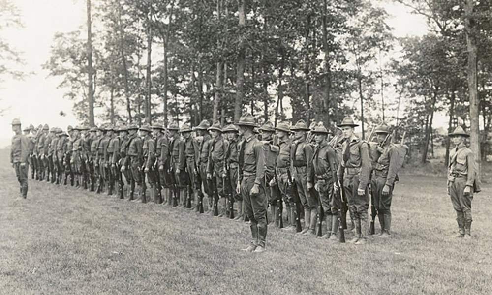 Uniformed soldiers standing in alignment.