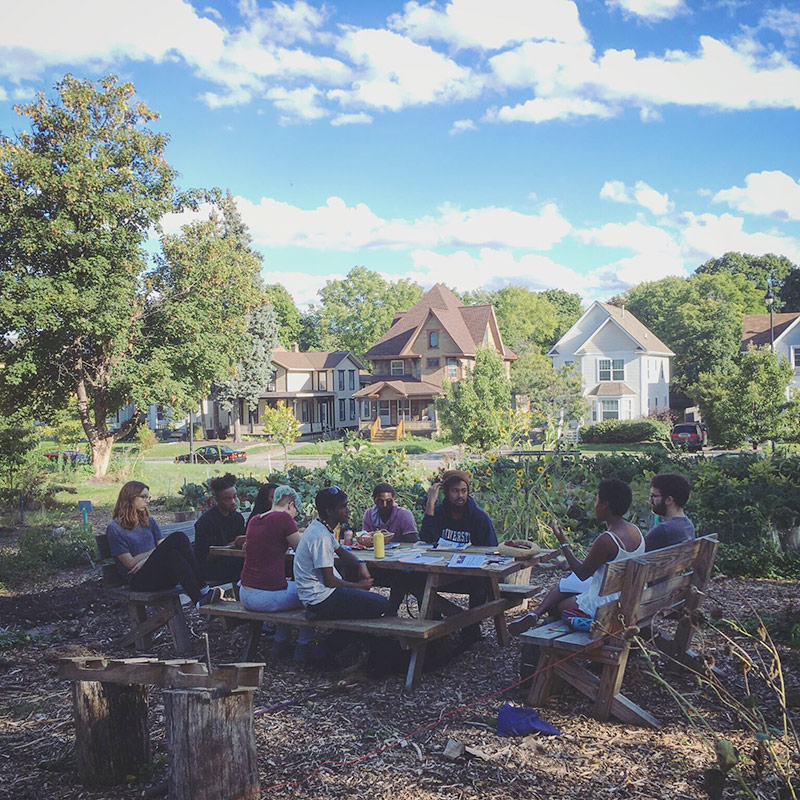 students sitting at picnic table