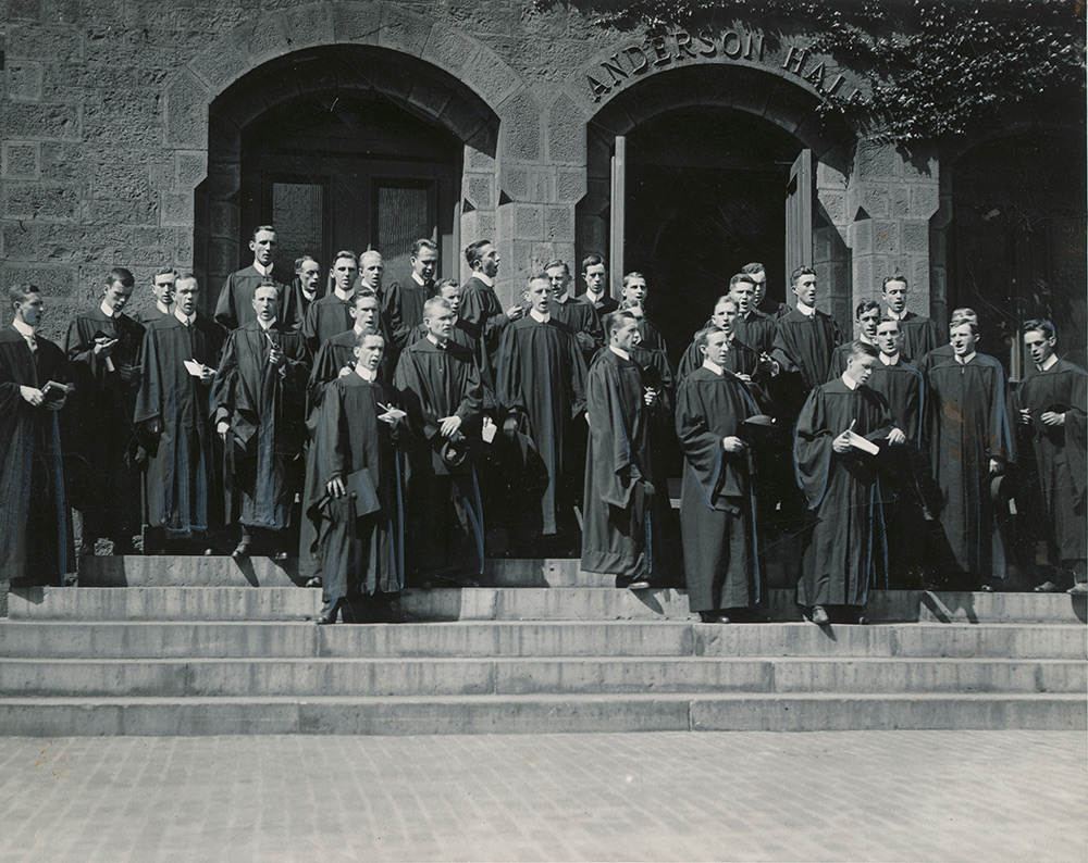 men in graduation robes singing