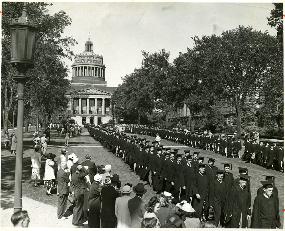 Male grads walking down the quad