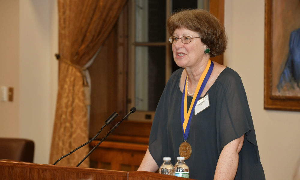 Feature image speaker behind podium