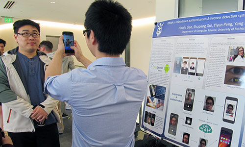 student taking photo of another student rolling his eyes