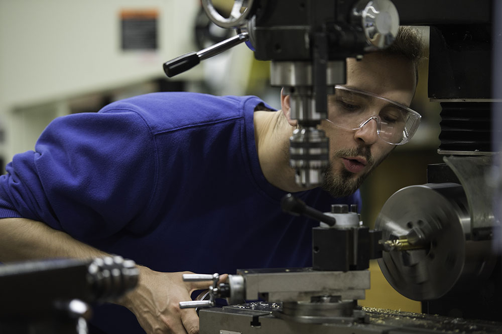 student using machine in fabrication lab