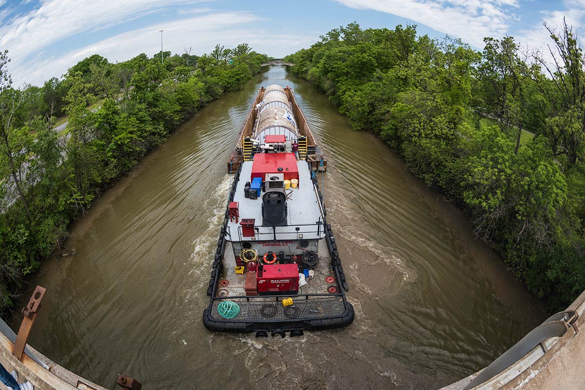 Feature image large barge in the Erie Canal holds three very large tanks