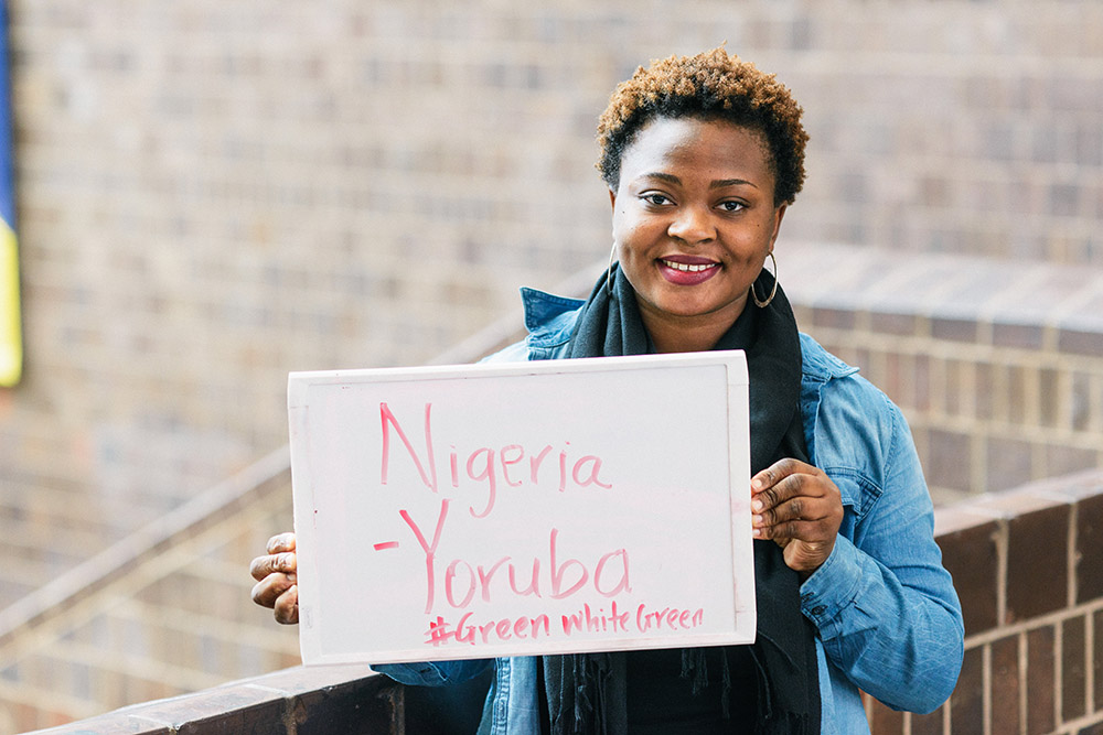 student holding sign with handwritten message