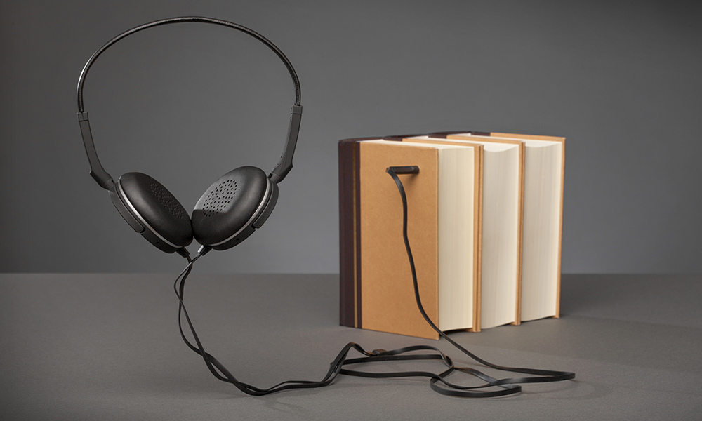 Feature image headphones plugged into books