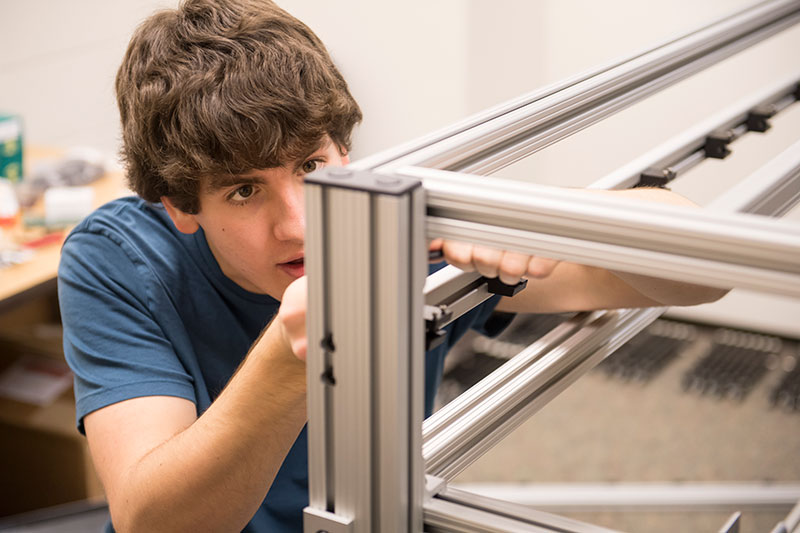 student constructing a metal frame