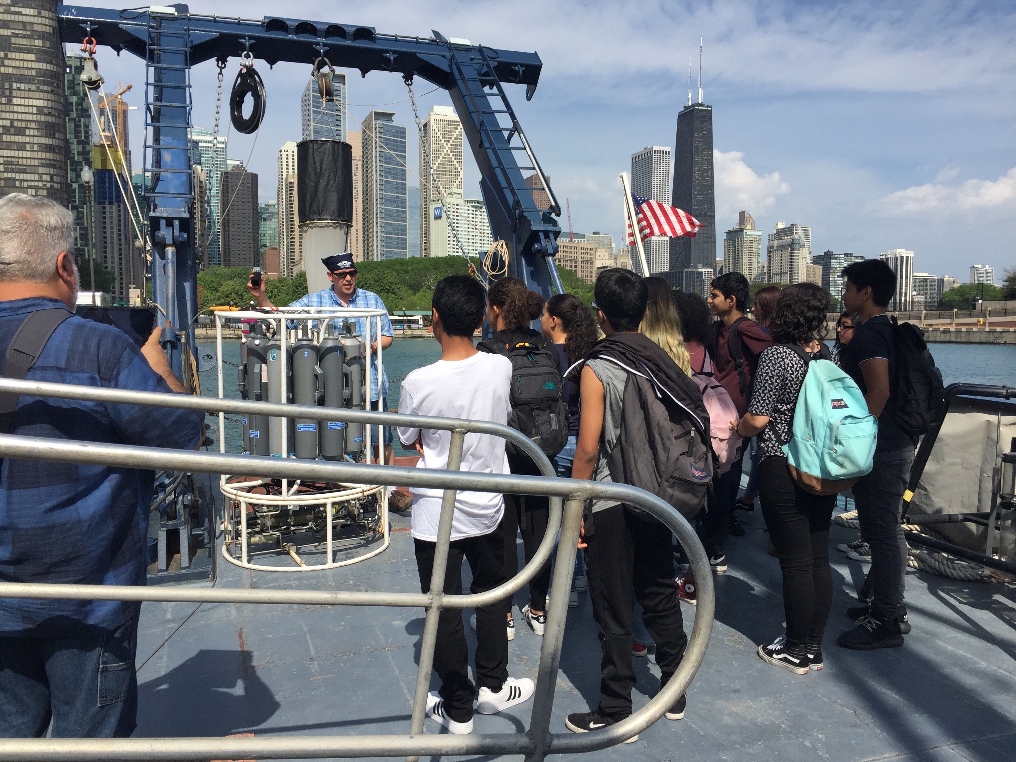 researcher talks to kids on a boat