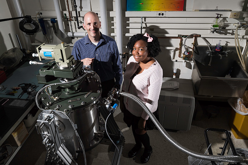 Feature image student and professor pose in lab