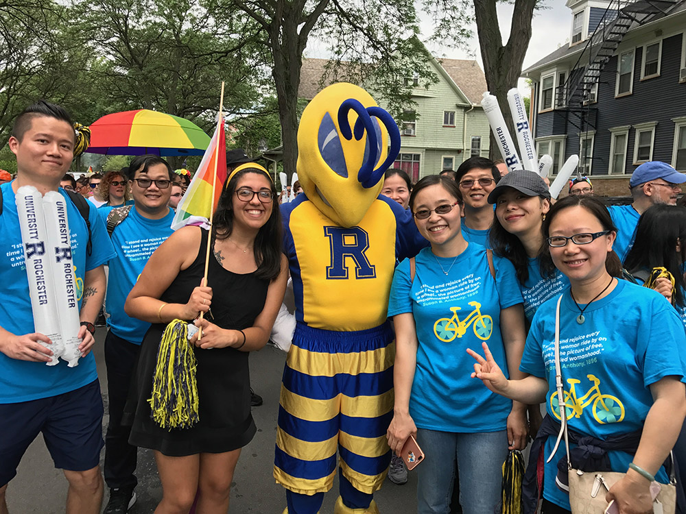 Feature image group of marchers in Pride Parade pose with the Rocky yellowjacket mascot