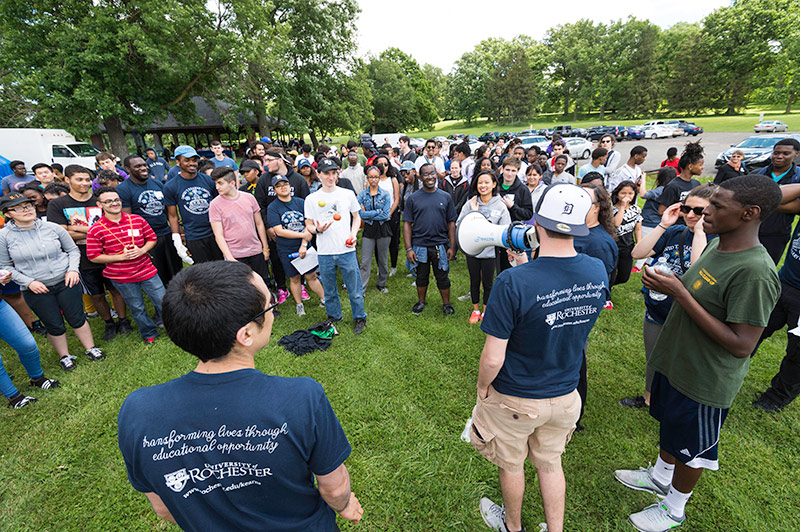 one student addresses large crowd with a bull horn