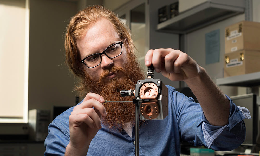 Feature image man adjusting metal measuring device