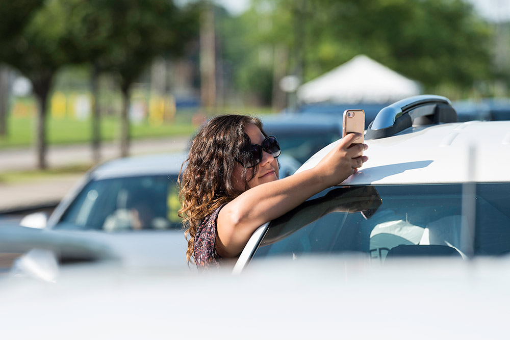 woman taking a photo with iPhone