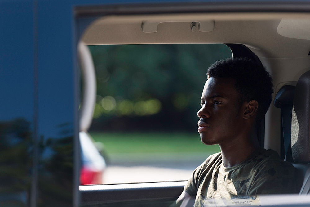 student sitting in car