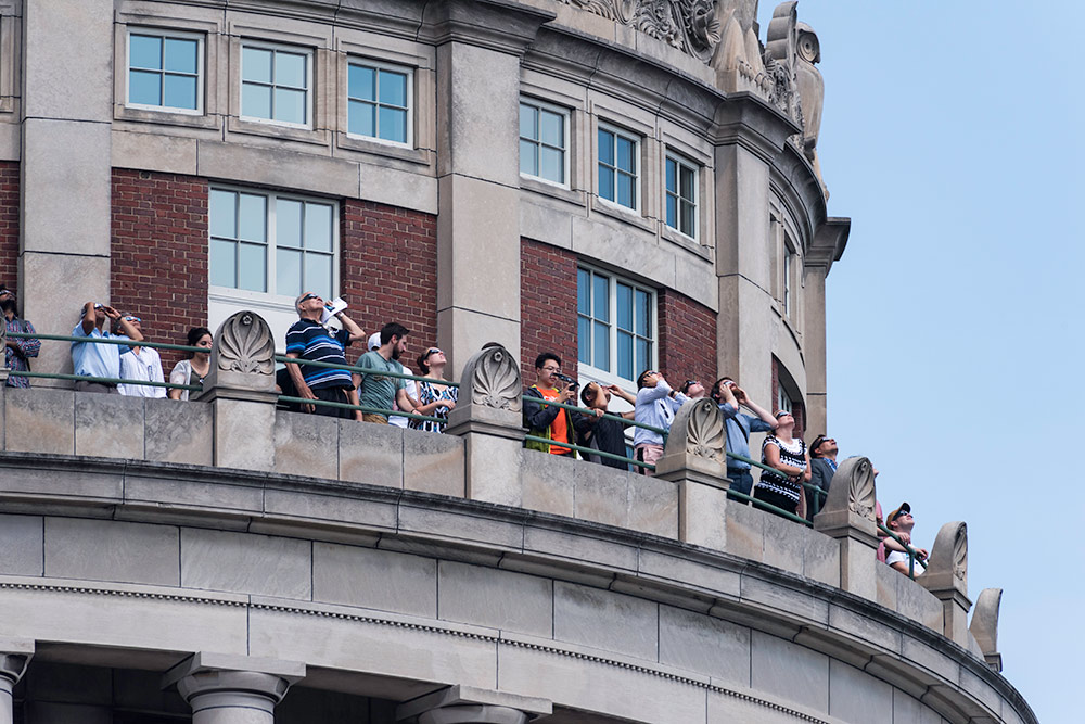 crowd of people along the walkway on the Rush Rhees Library tower