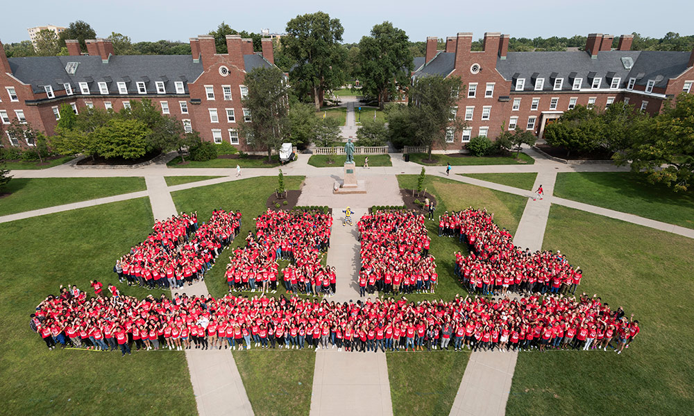 Feature image students wearing matching red t-shirts form the letters UR21
