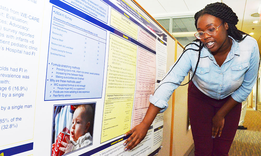 student at a poster presentation of her research results