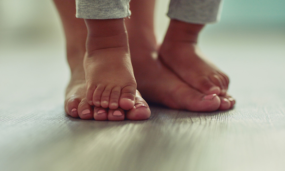Feature image child's feet on top of parent's feet