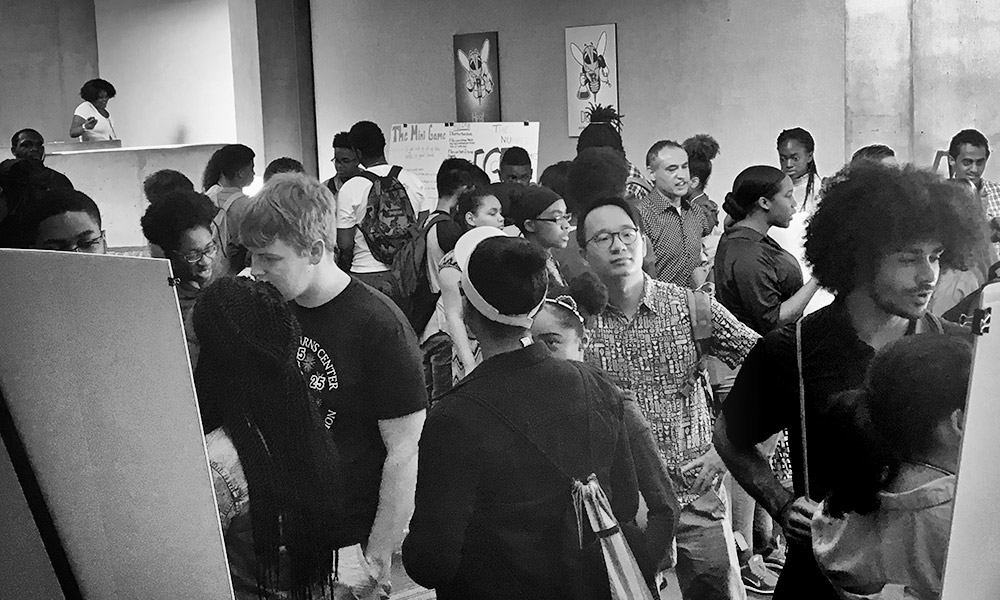 large group of students standing around posters