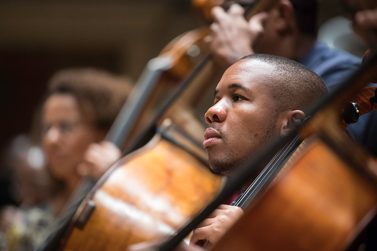 Feature image cellist on stage with other musicians