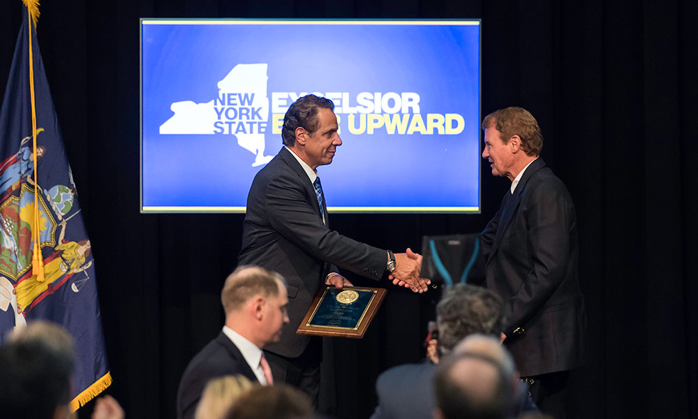 Andrew Cuomo shaking hands with Danny Wegman