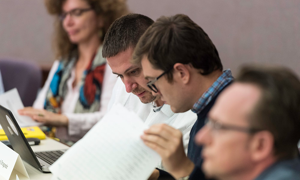 Feature image two students sharing notes in a classroom
