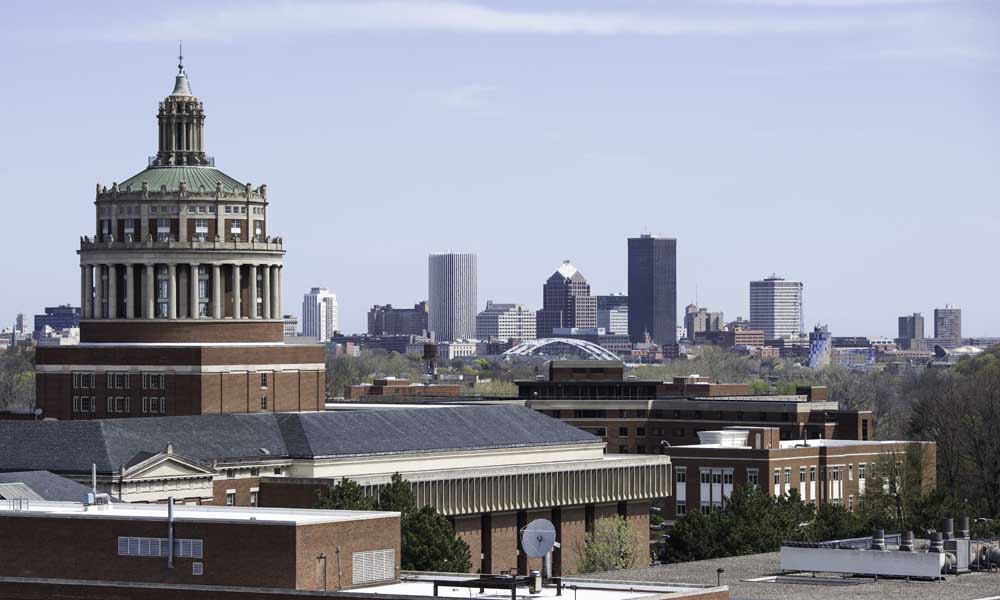 Rush Rhees Library with the city skyline in the background.