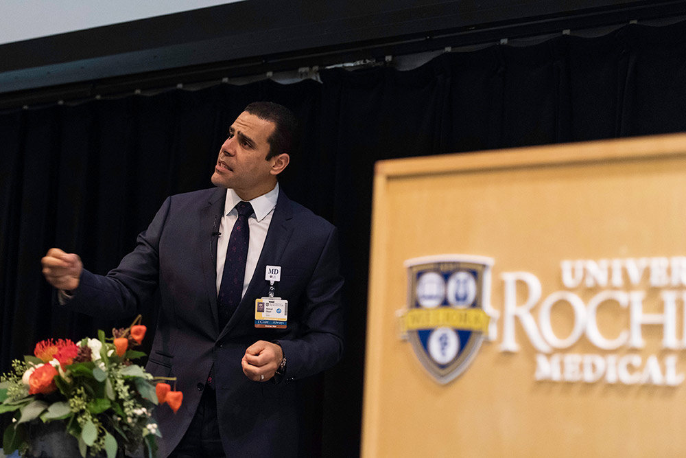 man giving presentation near UR Medicine podium